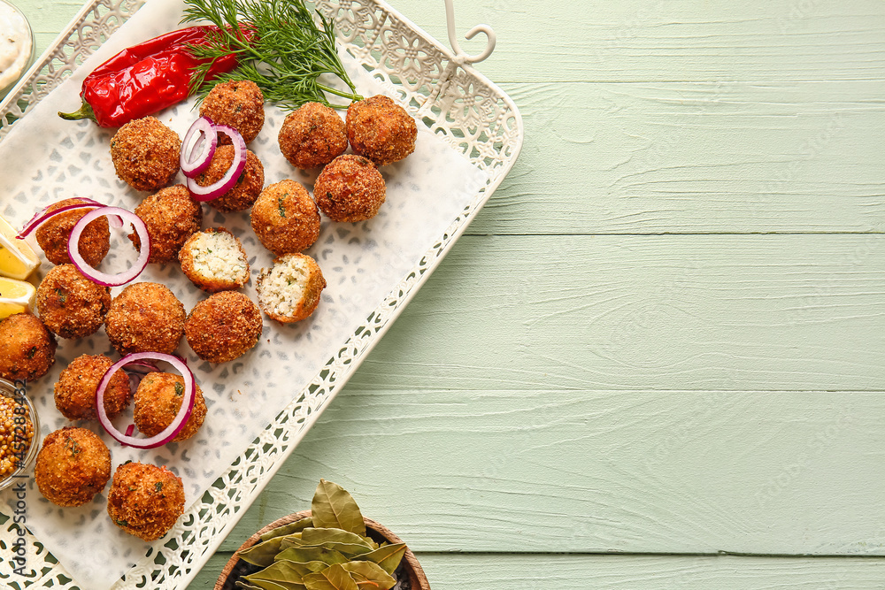 Fototapeta premium Tray with tasty cod cutlets, mustard and spices on color wooden background