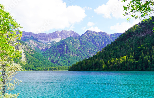 Landscape at the Plansee in Tyrol, Austria. Turquoise colored lake with surrounding landscape and mountains.
