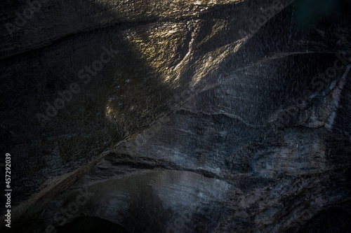 Dark rock with water flowing