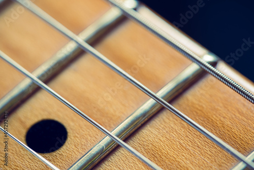 Detail of the neck and the strings of a red electric guitar