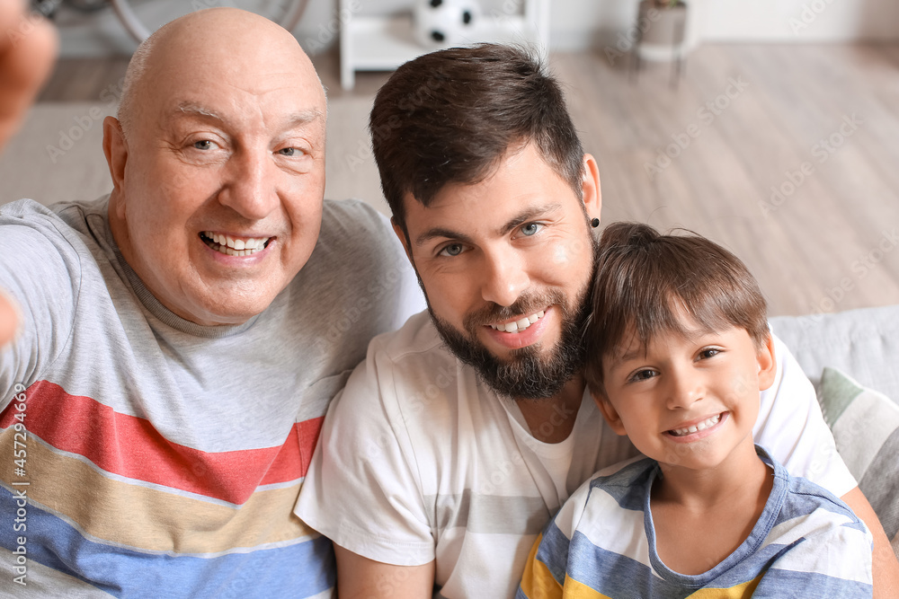 Happy man, his little son and father taking selfie at home Happy man, his little son and father taking selfie at home