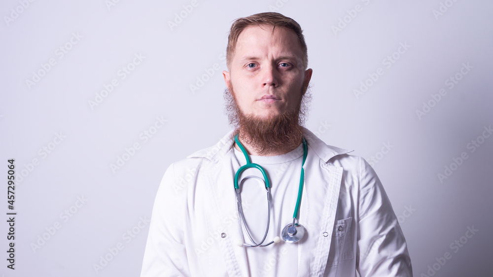 Male doctor in laboratory coat on gray background Male doctor in laboratory coat on gray background