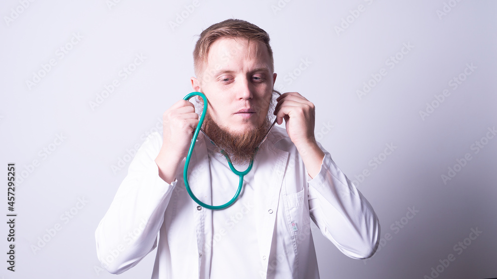 Male doctor in laboratory coat on gray background Male doctor in laboratory coat on gray background
