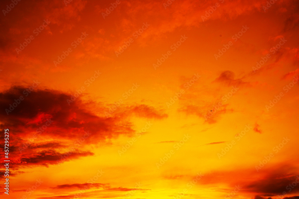 Fototapeta premium Colorful sunset. Red orange yellow sky with clouds. Beautiful bright evening sky background for design.
