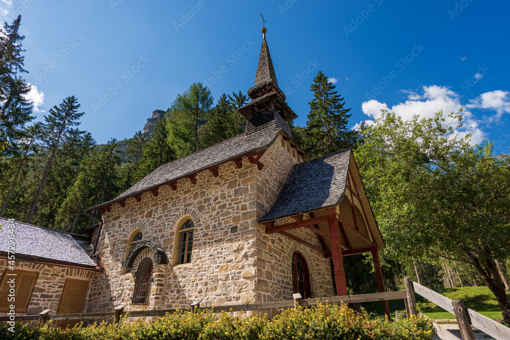 Small Church (Marienkapelle or Cappella di Maria) on the coast of Pragser Wildsee or Lago di Braies, small alpine lake in Braies valley, Dolomites, Trentino-Alto Adige, Bolzano, Italy, Europe.