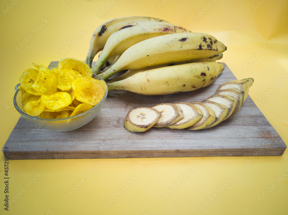 Home made Banana chips with Bunches of ripe yellow plantain, banana is