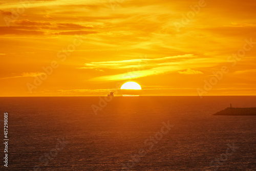 ships sailing on the horizon with sunset © IsmaelEstevez