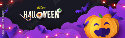 Halloween Promotion banner with cutest pumpkin and bats in night clouds on violet black background. Paper cut style. Halloween website Sale banner or header, horizontal poster template