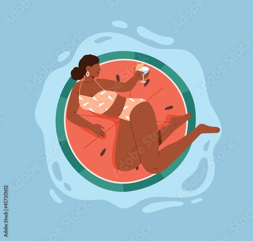 Woman in bikini floating on rubber ring in pool, relaxing with summer cocktai...