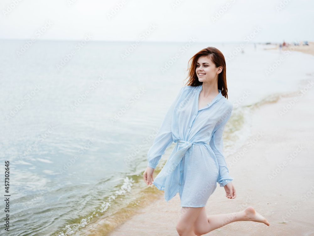 Woman in dress nature beach sand walk vacation Woman in dress nature beach sand walk vacation