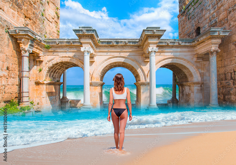 Beautiful Woman Walking On the Beach - View of Hadrian's Gate in old city of Antalya Beautiful Woman Walking On the Beach - View of Hadrian's Gate in old city of Antalya