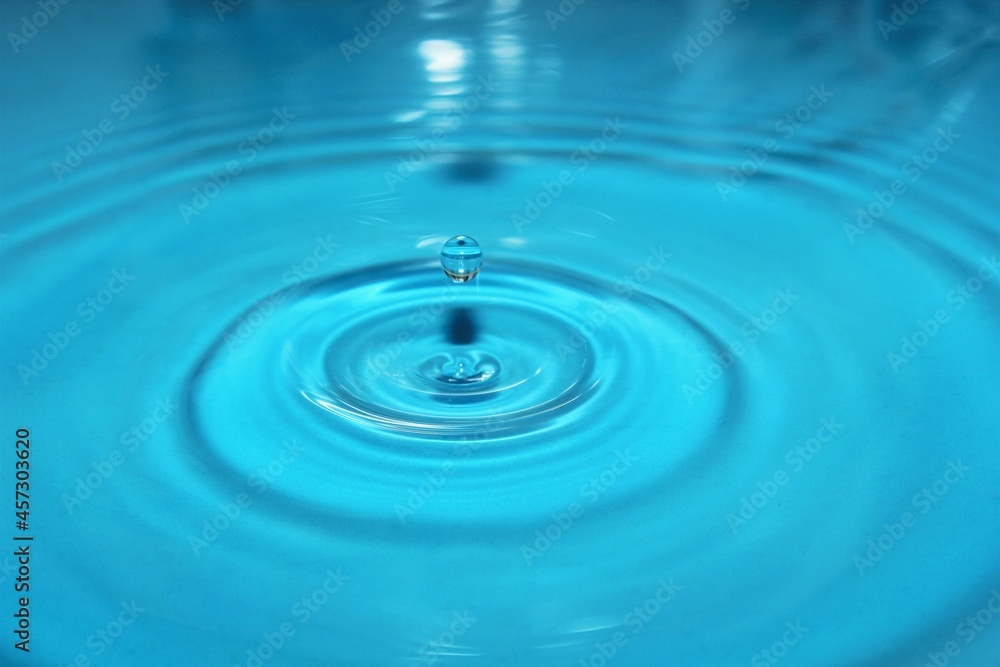 water drop splash background blue, water ripple and antibubble drop - water surface tension water drop splash background blue, water ripple and antibubble drop - water surface tension