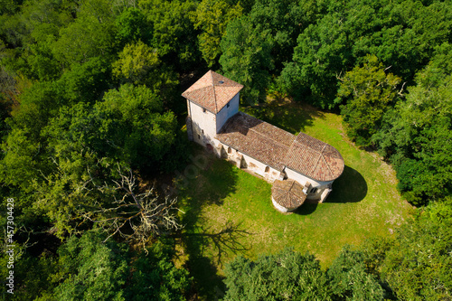 Aerial view of the old pilgrimage church of Lugo buitl in the middle of the forest. Gironde, France photo