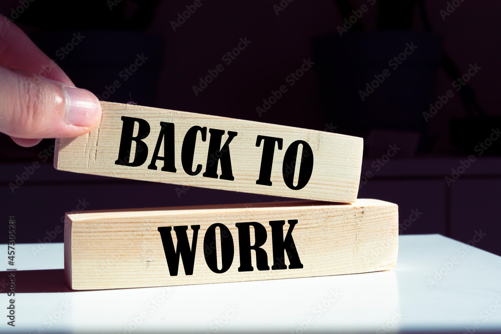 Back to work word written on wood block. Back to work word written on wood block.