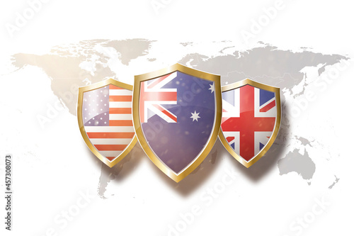 Us Australia and Great Britain flags in golden shield on world map background.aukus defense pact. photo