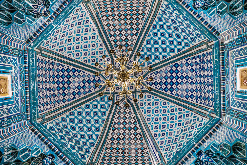 Details of vaulting with Eastern ornaments. Medieval mausoleum of Qutham ibn Abbas of XIV century. Historical complex Shah-i Zinda, Samarkand, Uzbekistan