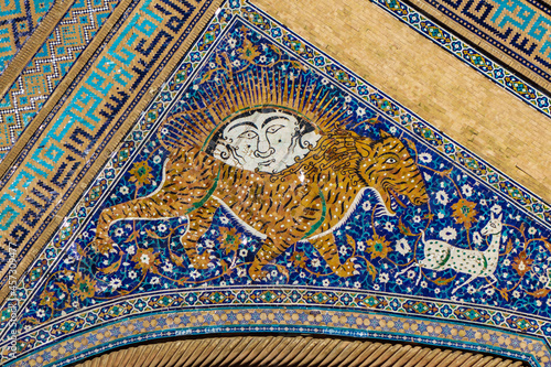 Details of the facade of the madrasah. Lion hunting scene. Sher-Dor Madrasah in Samarkand, Uzbekistan