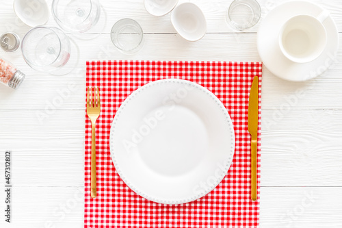 Dinner plate setting with cutlery and napkin. Top view