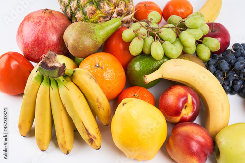 Mix of fresh juicy colorful exotic tropical fruits on white background