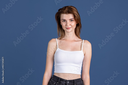 Traditional portrait of young girl isolated on old navy color studio background. Concept of human emotions, facial expression, natural beauty, appearance, youth