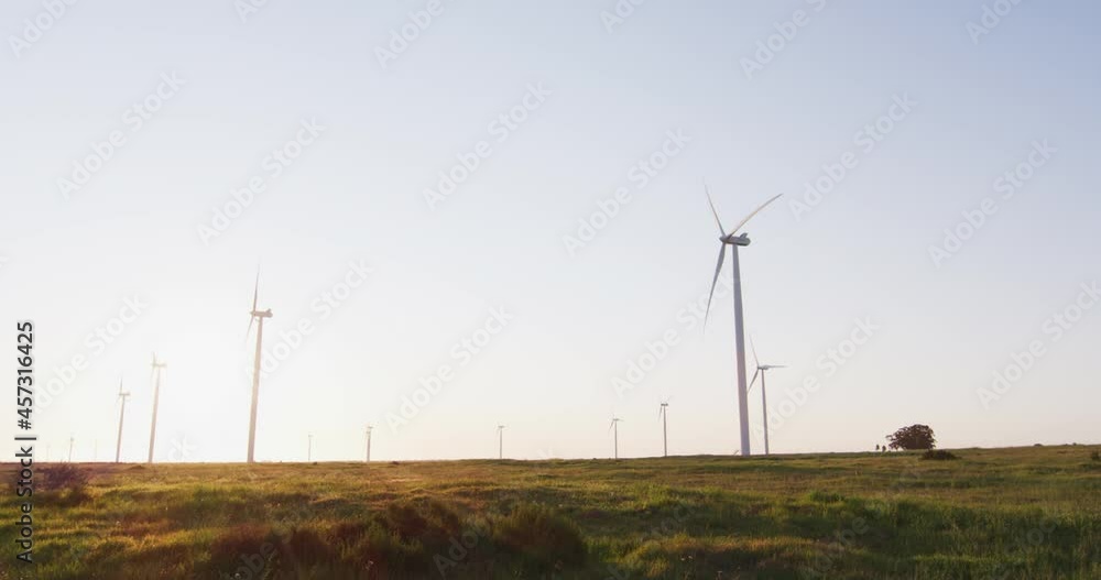 General view of wind turbines in countryside landscape with cloudless sky General view of wind turbines in countryside landscape with cloudless sky