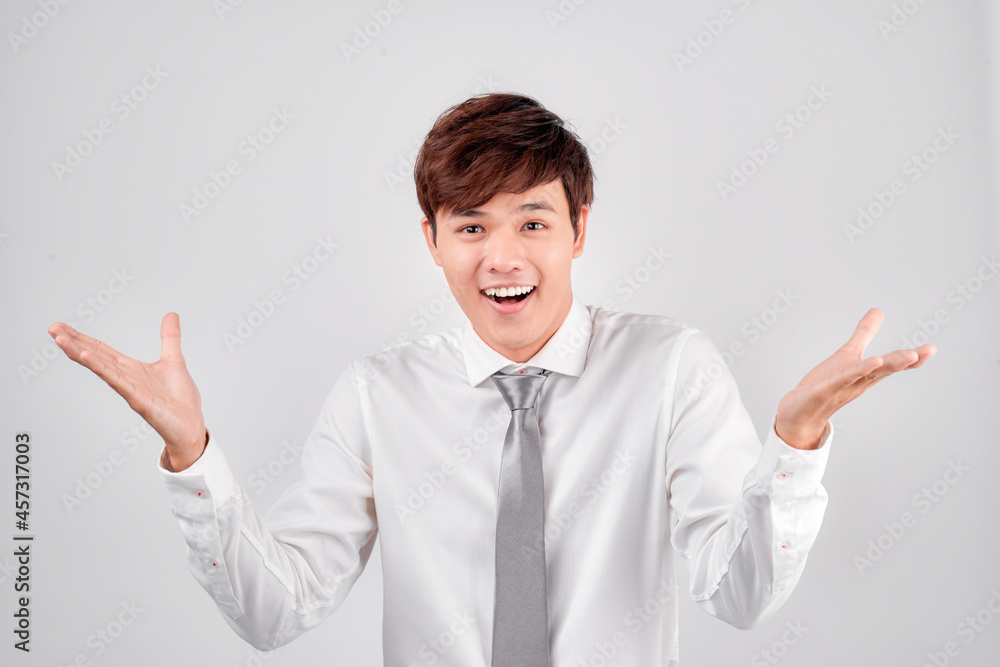 Happy asian man greeting somebody over white background. Looking at camera Happy asian man greeting somebody over white background. Looking at camera