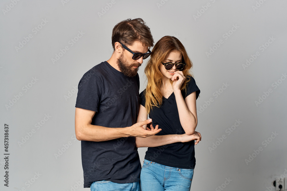 married couple in black t-shirt sunglasses posing isolated background married couple in black t-shirt sunglasses posing isolated background