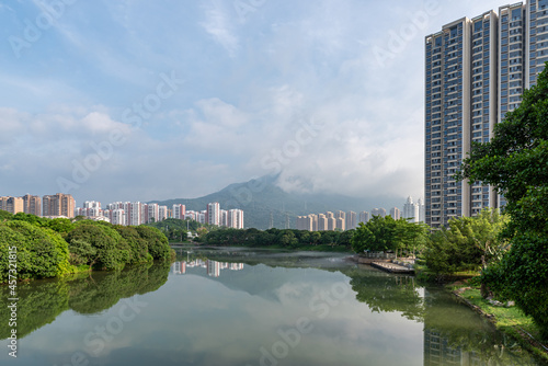 Streams reflect the city and forest in the morning fog © chen