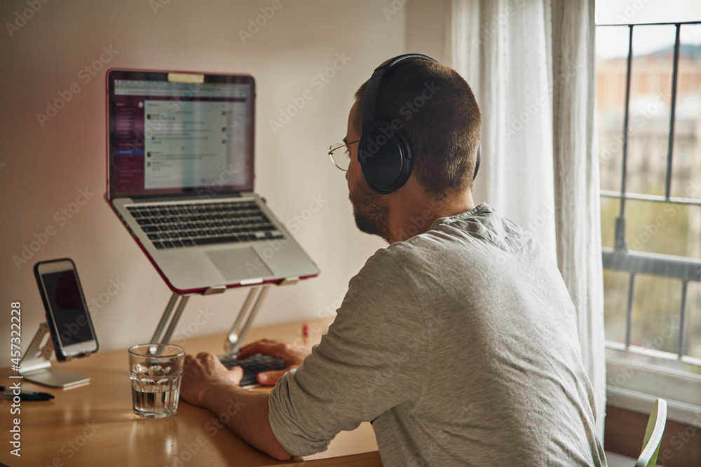 Immersed man sitting at a desk in mid-typing Immersed man sitting at a desk in mid-typing