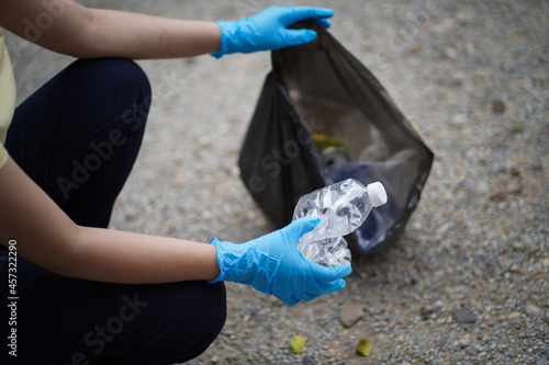 Volunteer charity woman  hand holding garbage black bag and plastic bottle garbage for recycling for cleaning at park volunteering concept reuse and volunteer helping