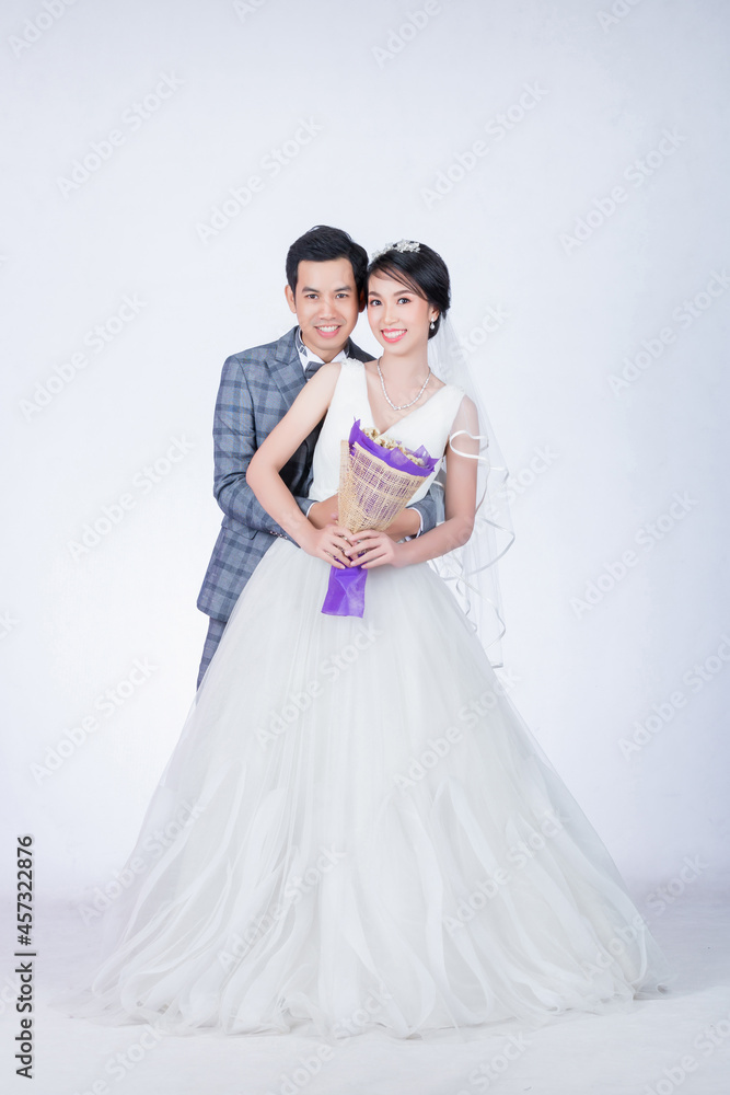 portrait of bride and groom on isolated white background