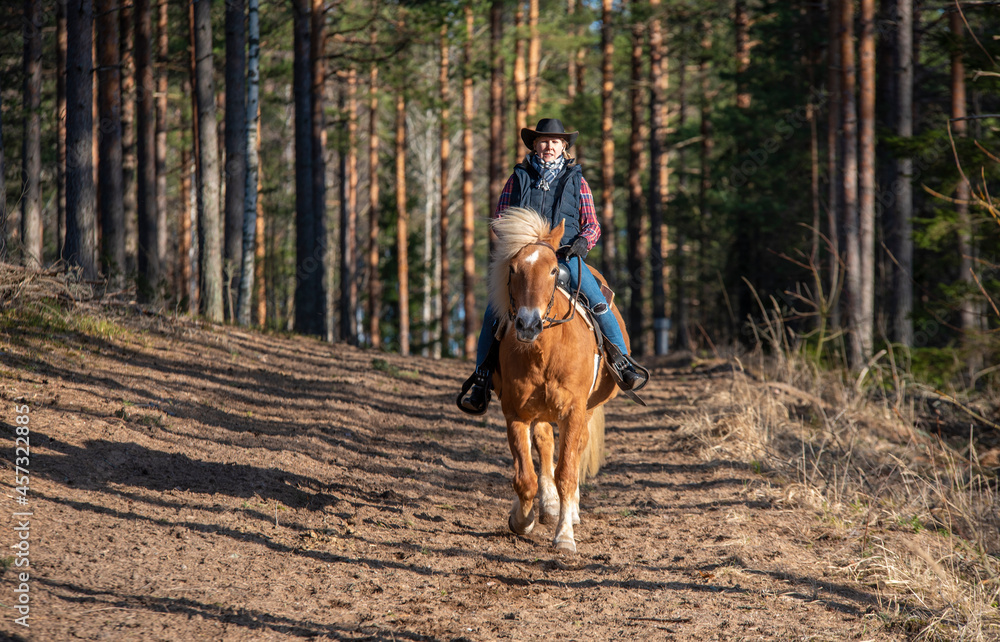 Woman horseback riding in forest Woman horseback riding in forest