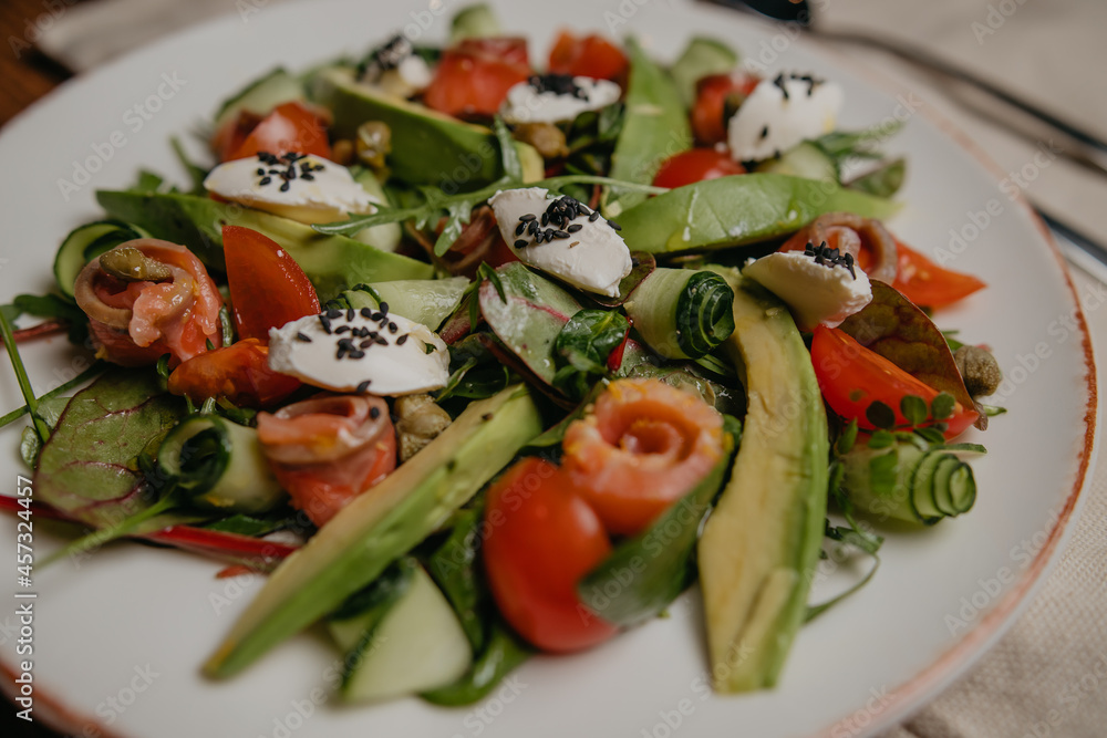 salad with salmon, avocado and cheese
