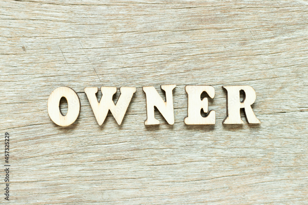 Alphabet letter in word owner on wood background Alphabet letter in word owner on wood background