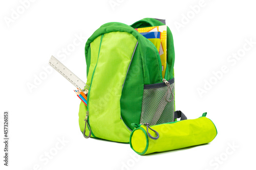 green school backpack with books, pencils and a chalkboard isolated on white, back to school
