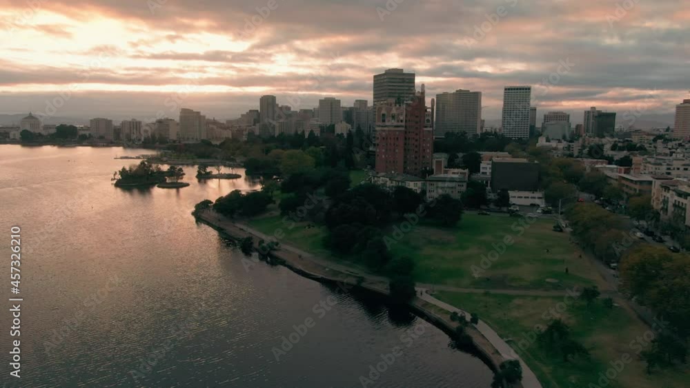 Aerial: Oakland Lake Merritt and city skyline at sunset. California, USA Aerial: Oakland Lake Merritt and city skyline at sunset. California, USA