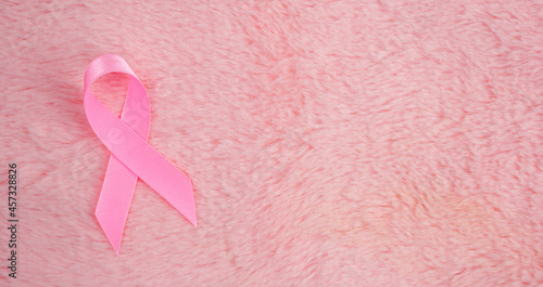 pink ribbon breast cancer on pink background. with copy space.