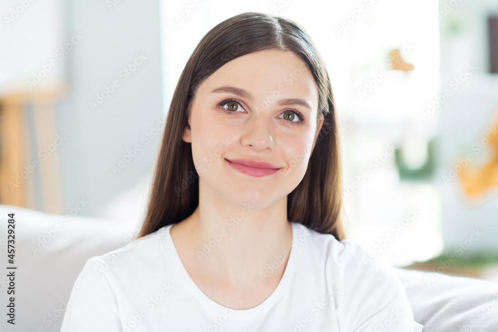 Portrait of attractive cheerful brunette girl sitting on divan spending day daydream calm rest at home indoors Portrait of attractive cheerful brunette girl sitting on divan spending day daydream calm rest at home indoors