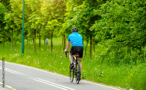 Wallpaper Mural Cyclist ride on the bike path in the city Park
 Torontodigital.ca