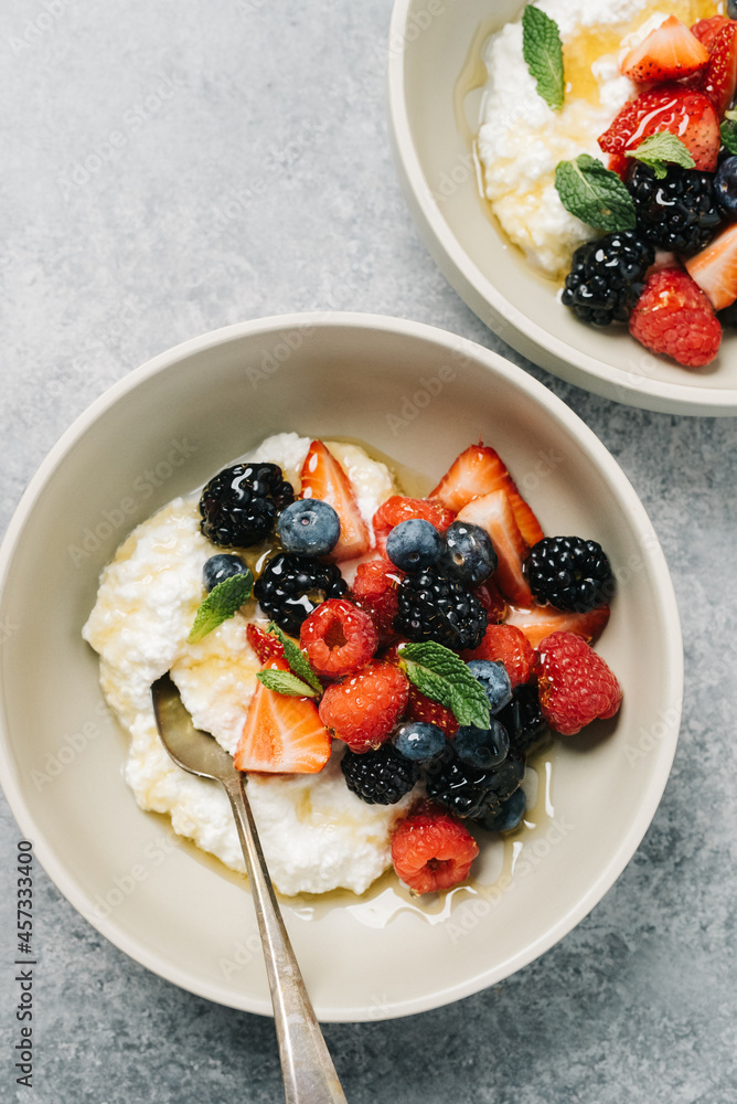 Ricotta cheese breakfast bowl with berries and mint