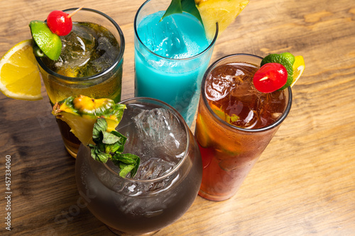 Tropical cocktails on wooden background. Frutal alcoholic cocktails.