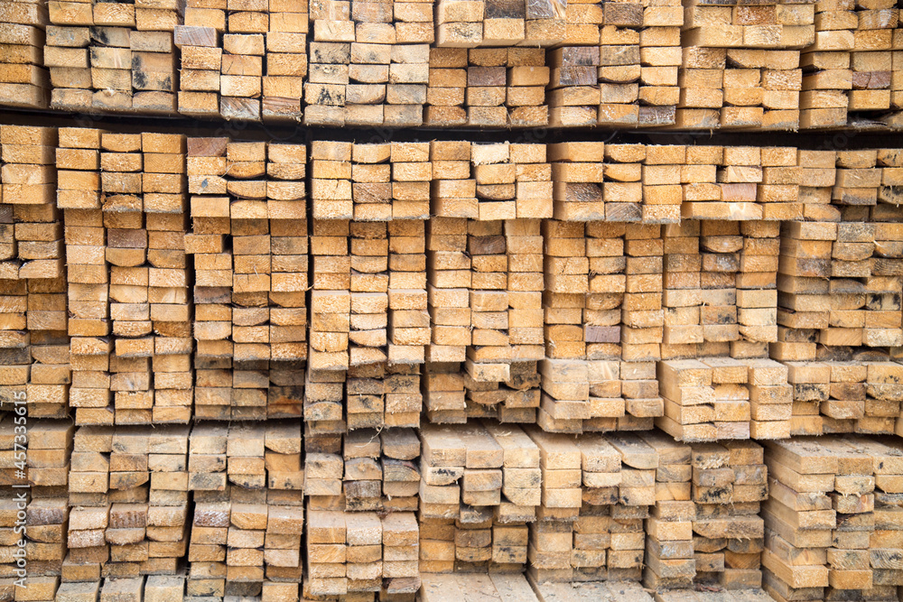 The background of the ends of the edged softwood board is yellow with a beautiful pattern of the tree structure. Design backgrounds textures construction. The background of the ends of the edged softwood board is yellow with a beautiful pattern of the tree structure. Design backgrounds textures construction.