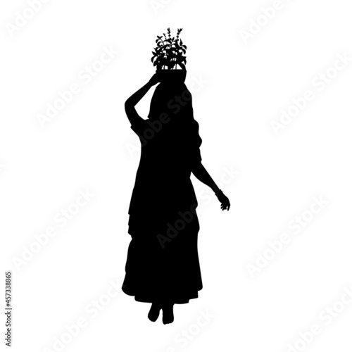 Silhouette Indian woman carries holy basil or tulasi vrindavan on her head. Indian culture and religion.