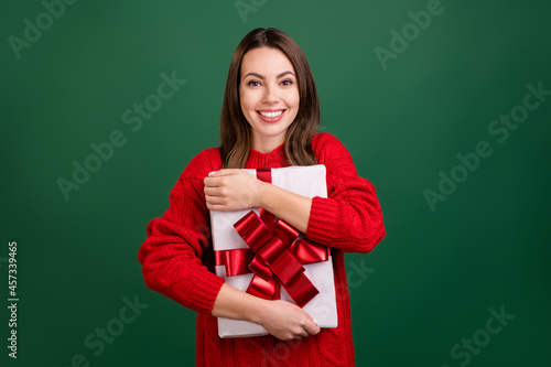 Photo of young cheerful girl happy positive smile hug cuddle embrace present box isolated over green color background photo