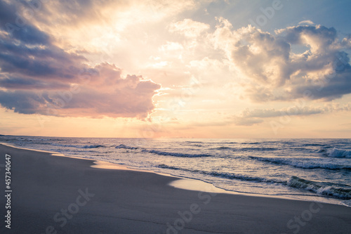 Beautiful sunset over a sandy seaside beach.