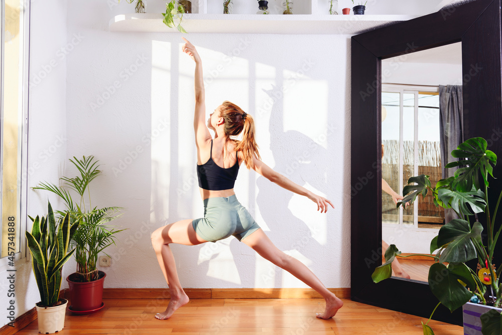 Flexible woman practicing yoga in warrior two pose Flexible woman practicing yoga in warrior two pose