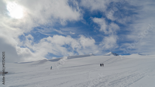 The image of snowboarders on a snowy mountain top.