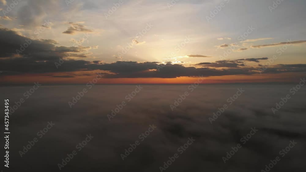 Flying over the clouds. Beautiful sunrise or sunset over the clouds. Orange sky. Beautiful sunrise landscape with morning mist. Aerial view. Colorful sky background Flying over the clouds. Beautiful sunrise or sunset over the clouds. Orange sky. Beautiful sunrise landscape with morning mist. Aerial view. Colorful sky background