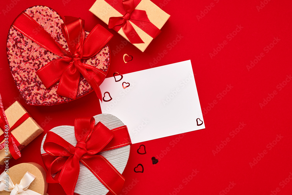 Various choices gift box in the form of heart with a red ribbon on a red background. Valentines day concept postcard. Top view flat lay with copy space. Various choices gift box in the form of heart with a red ribbon on a red background. Valentines day concept postcard. Top view flat lay with copy space.