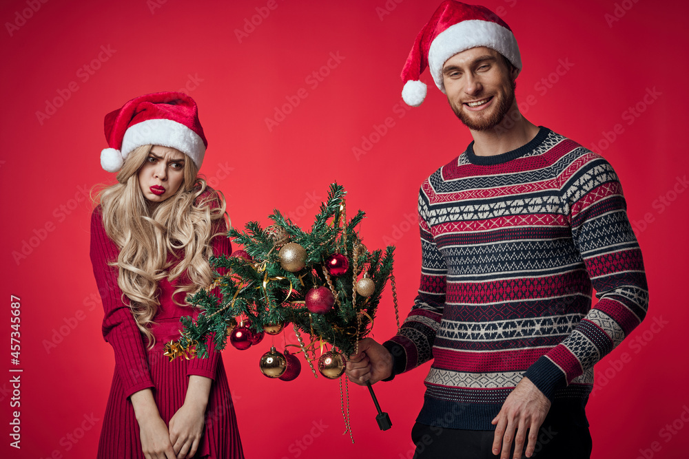 cheerful young couple in new year clothes holiday toys decoration cheerful young couple in new year clothes holiday toys decoration